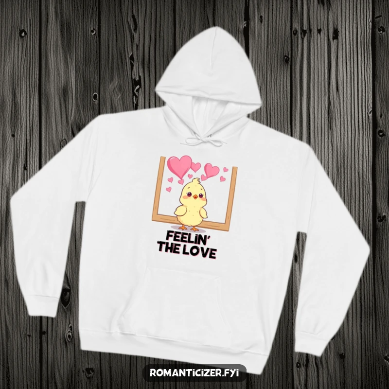 Funny chick hoodie with a cheerful bird captivated by a heart painting, perfect for cozy, humorous art appreciation. A cute gift.