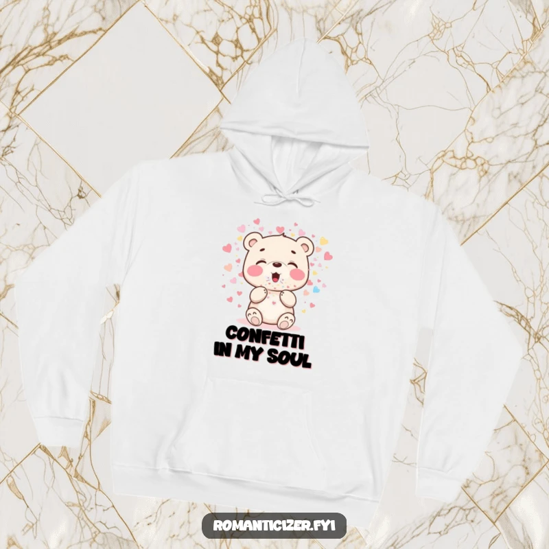 Funny bear cub hoodie featuring a cheerful cub blowing sparkling heart confetti, ideal for festive occasions and comfort.