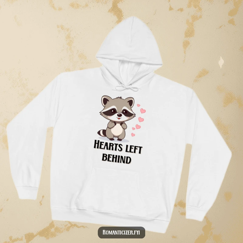 Funny raccoon hoodie depicting a raccoon leaving a trail of sparkling hearts, a cozy and funny representation of playful love.